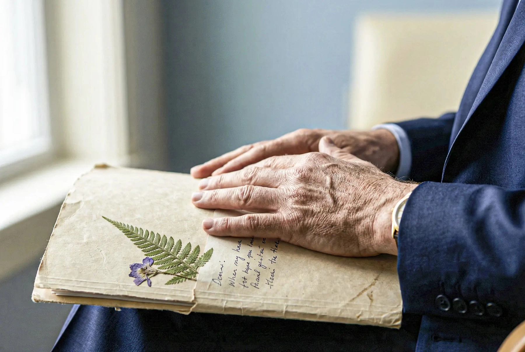 A vintage journal and a pressed fern — memory, kept gently