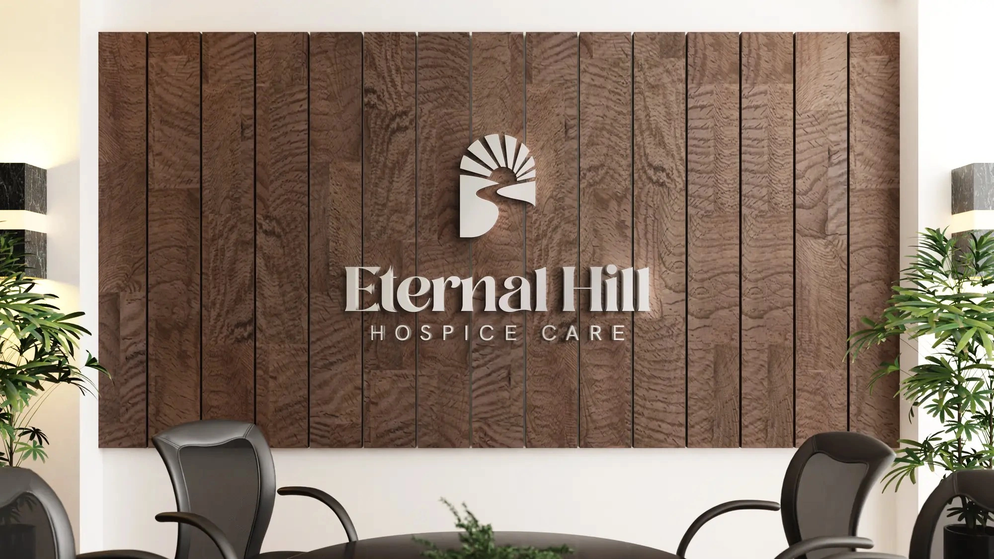 Reception signage — the wordmark in dimensional brushed letters on warm oak