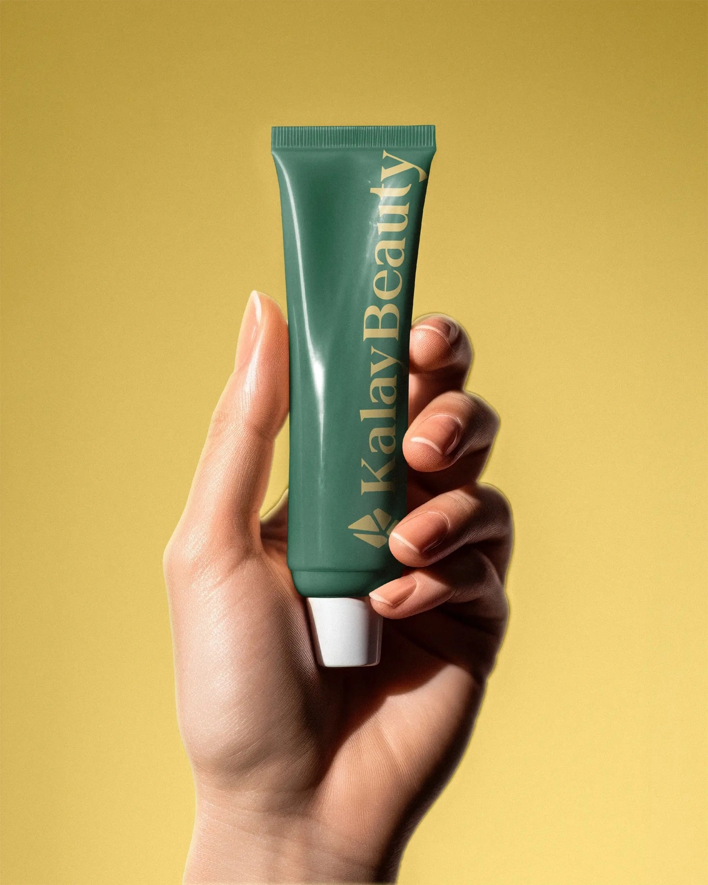 In hand — the emerald tube, the gem struck in gold